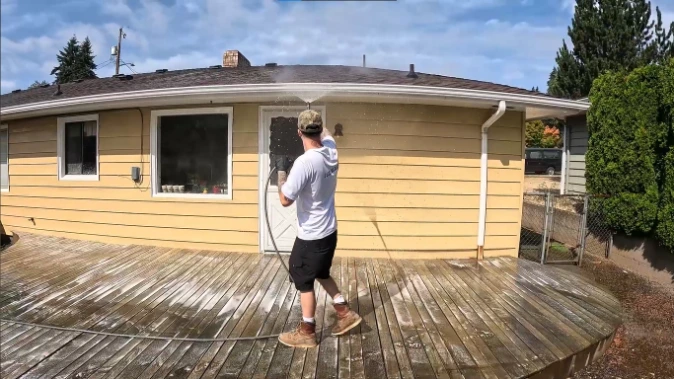 Pool deck pressure washing service cleaning wood deck and house siding